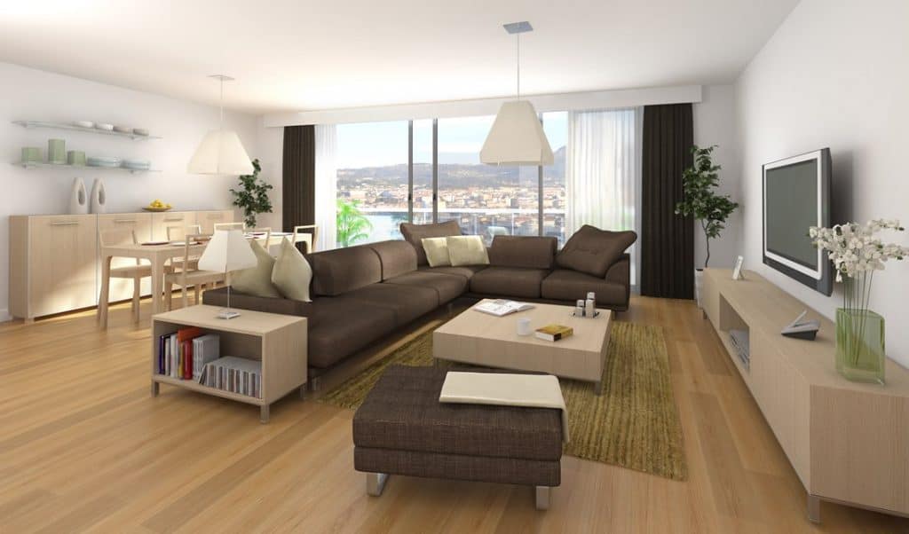 Modern condo living room interior with brown sofa, throw pillows and city view window