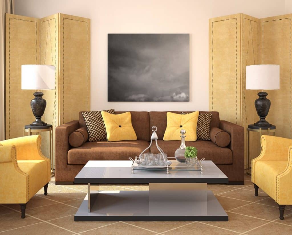 Eclectic living room with brown sofa, throw pillows and bright yellow armchairs