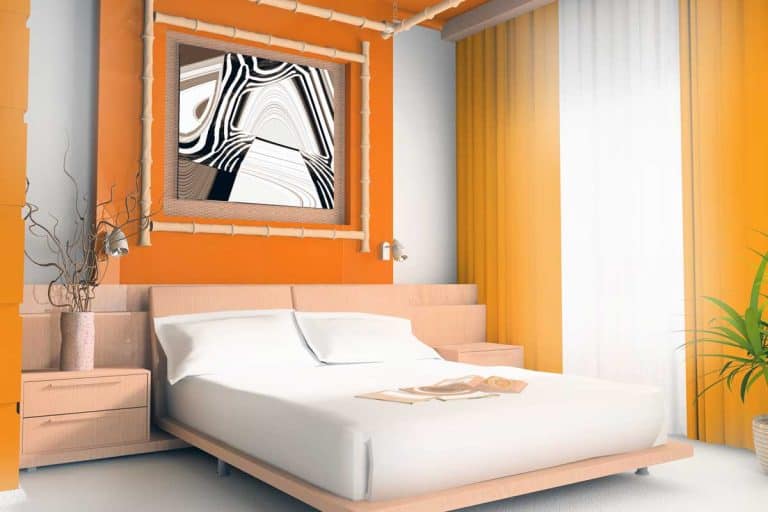 Interior of a modern orange bedroom with white beddings, orange painted walls, and a small indoor plant on the side, 30+ Awesome Orange Bedroom Ideas That Will Inspire You
