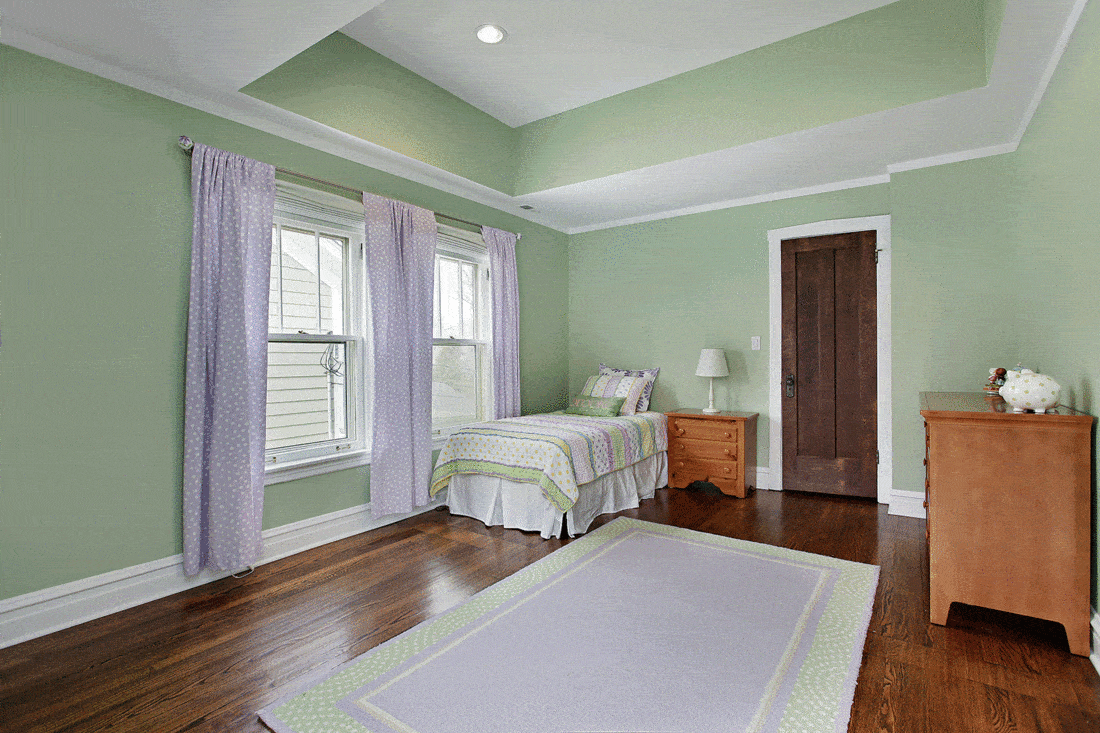 Bedroom in suburban home with green walls