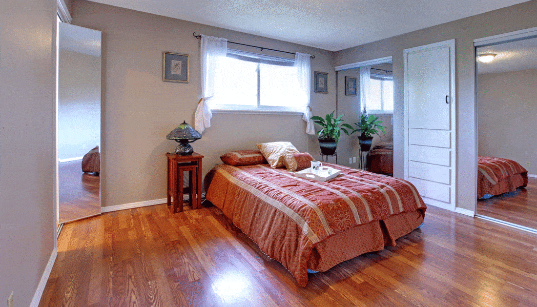 Bedroom with plant interior and wood flooring