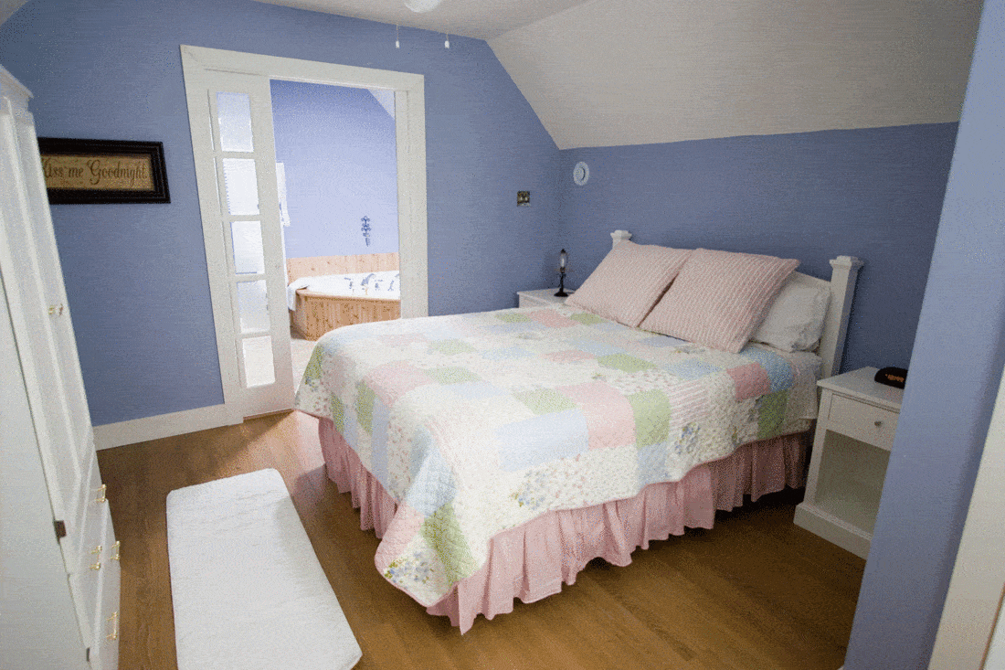 Cozy bedroom with wood flooring