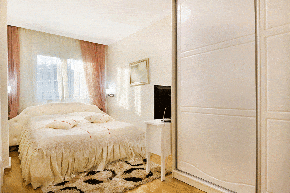 Cozy white bedroom with tv