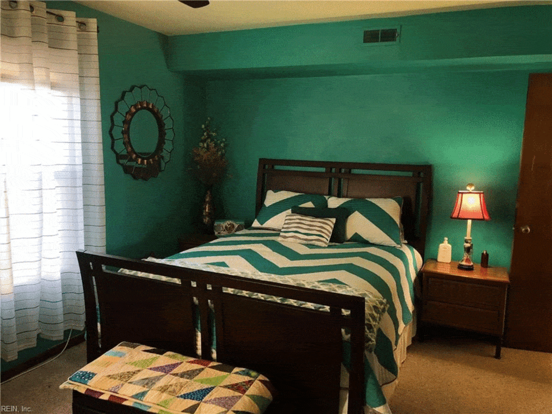 Dark green bedroom with patterned sheets
