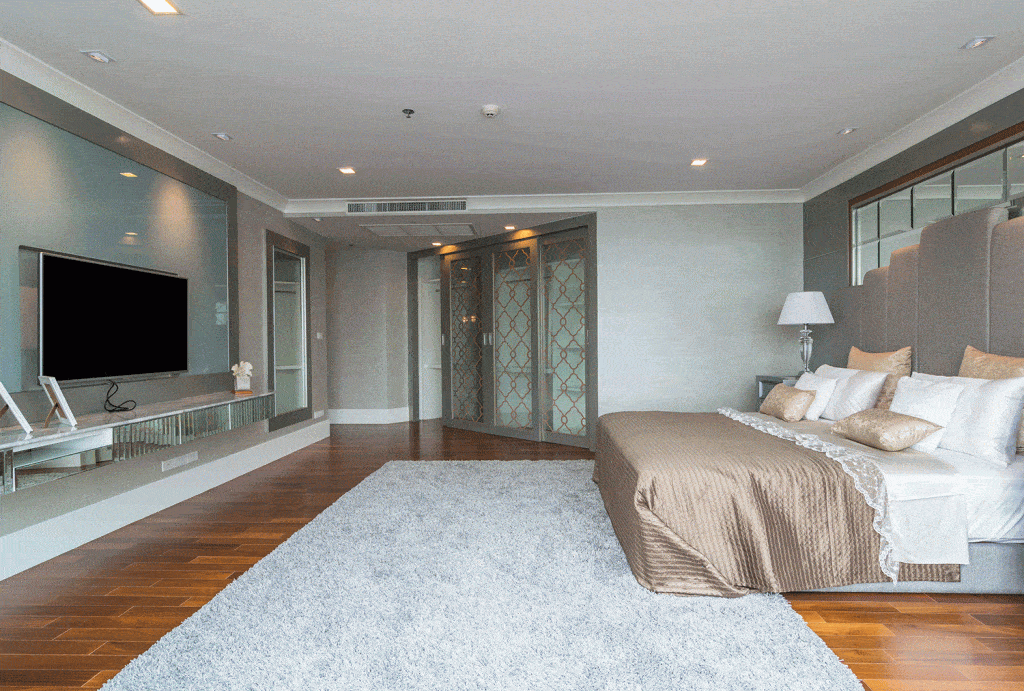 Elegant large master bedroom with wooden carpet flooring