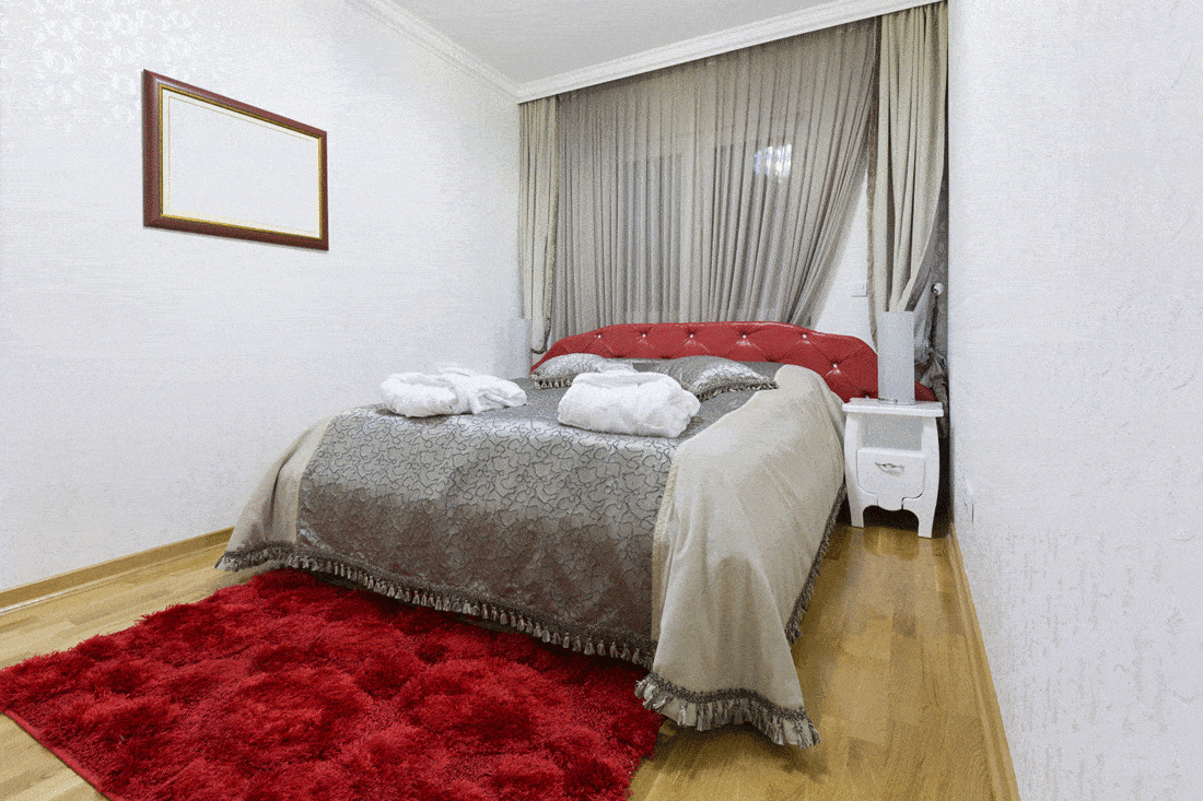 Grey bedroom with red carpet