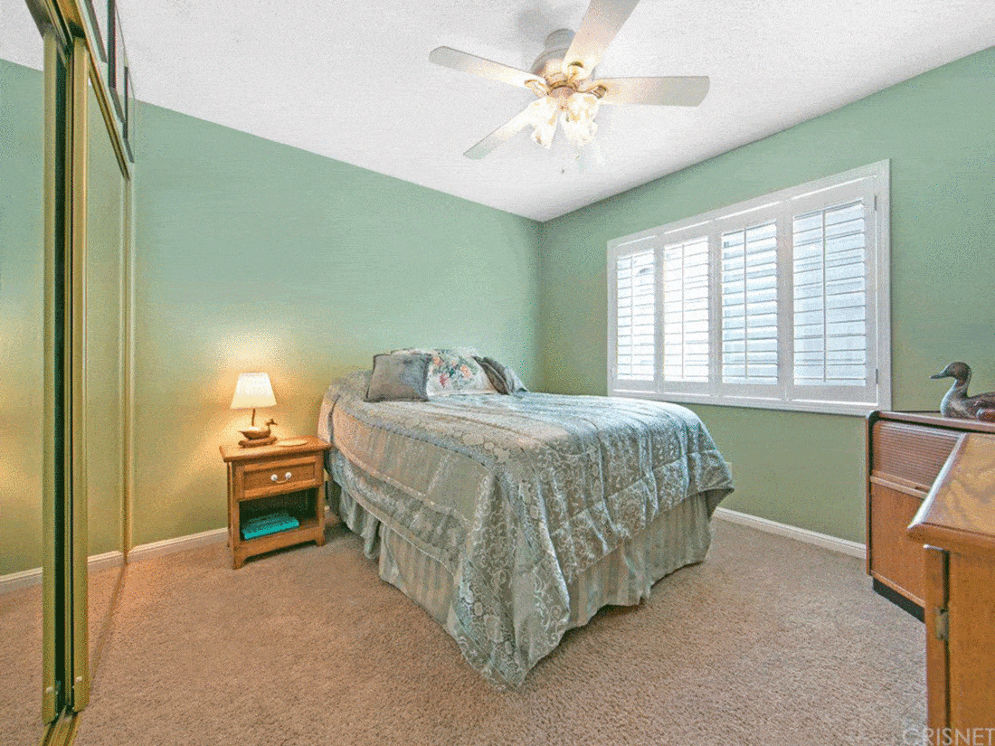 Light green wall bedroom with carpet and lamp