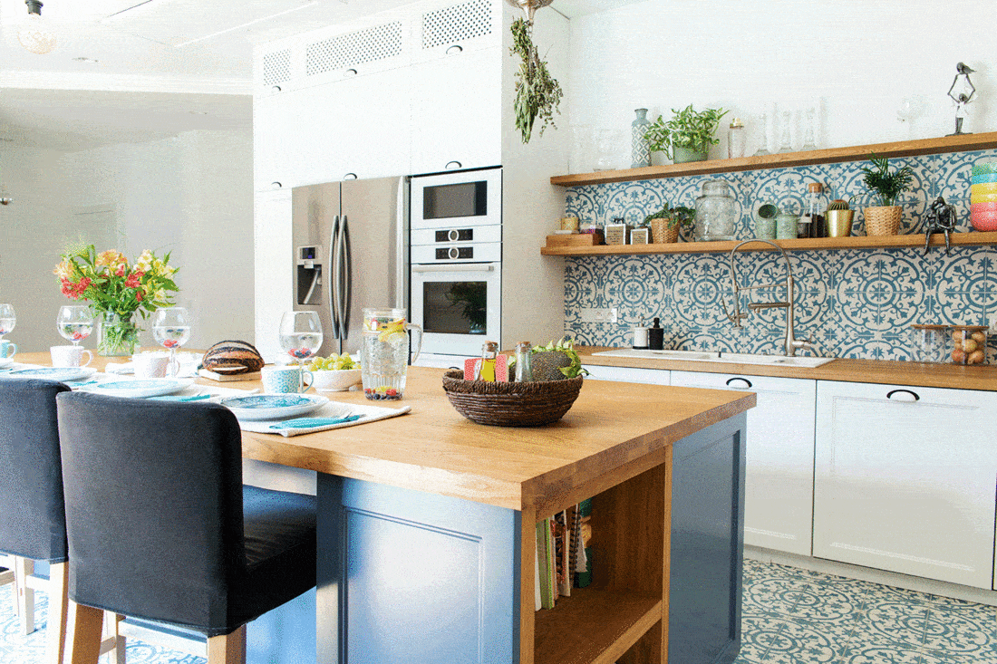 Stylish and sunny blue kitchen interior with plants
