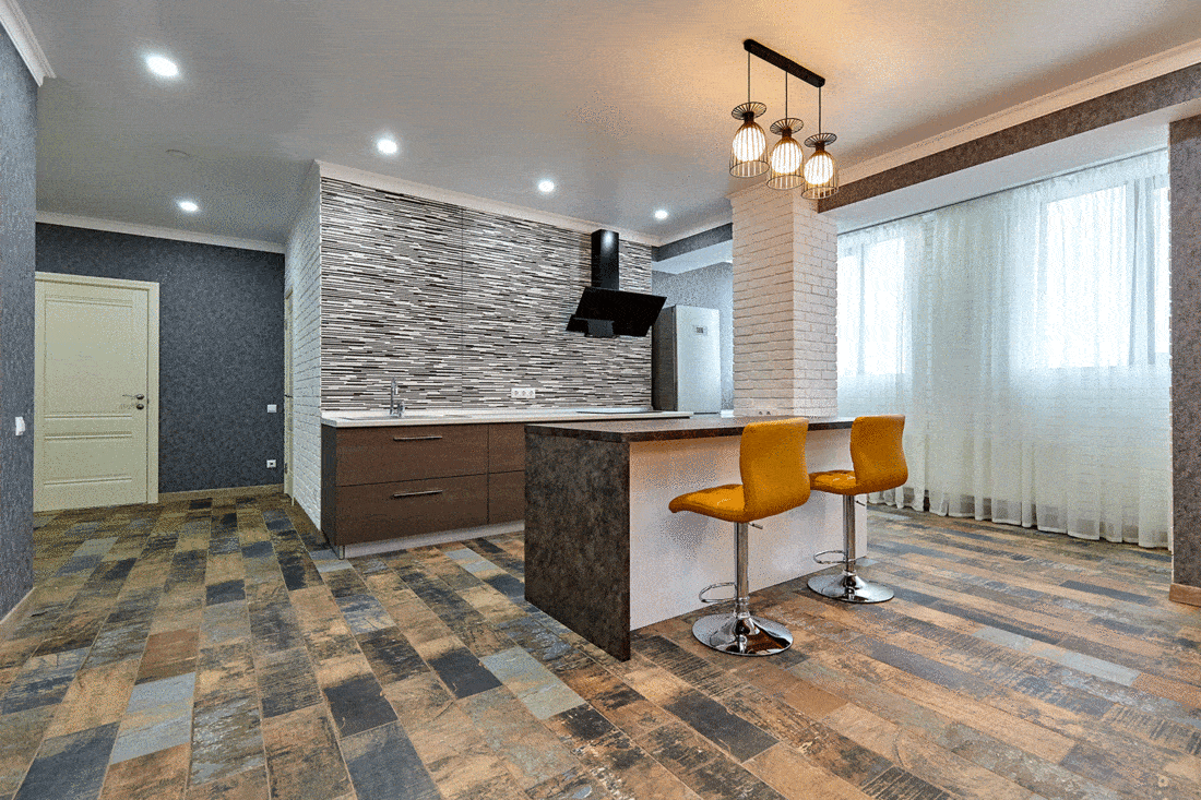 Stylish kitchen with brick wall and wood carpet