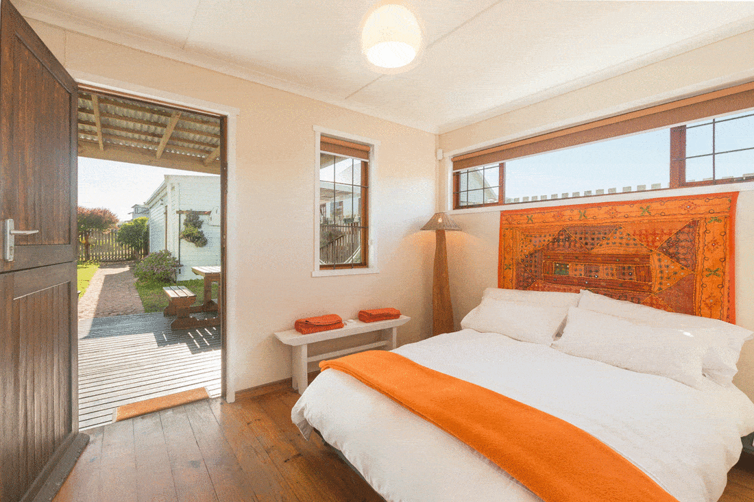 White and orange boho style bedroom