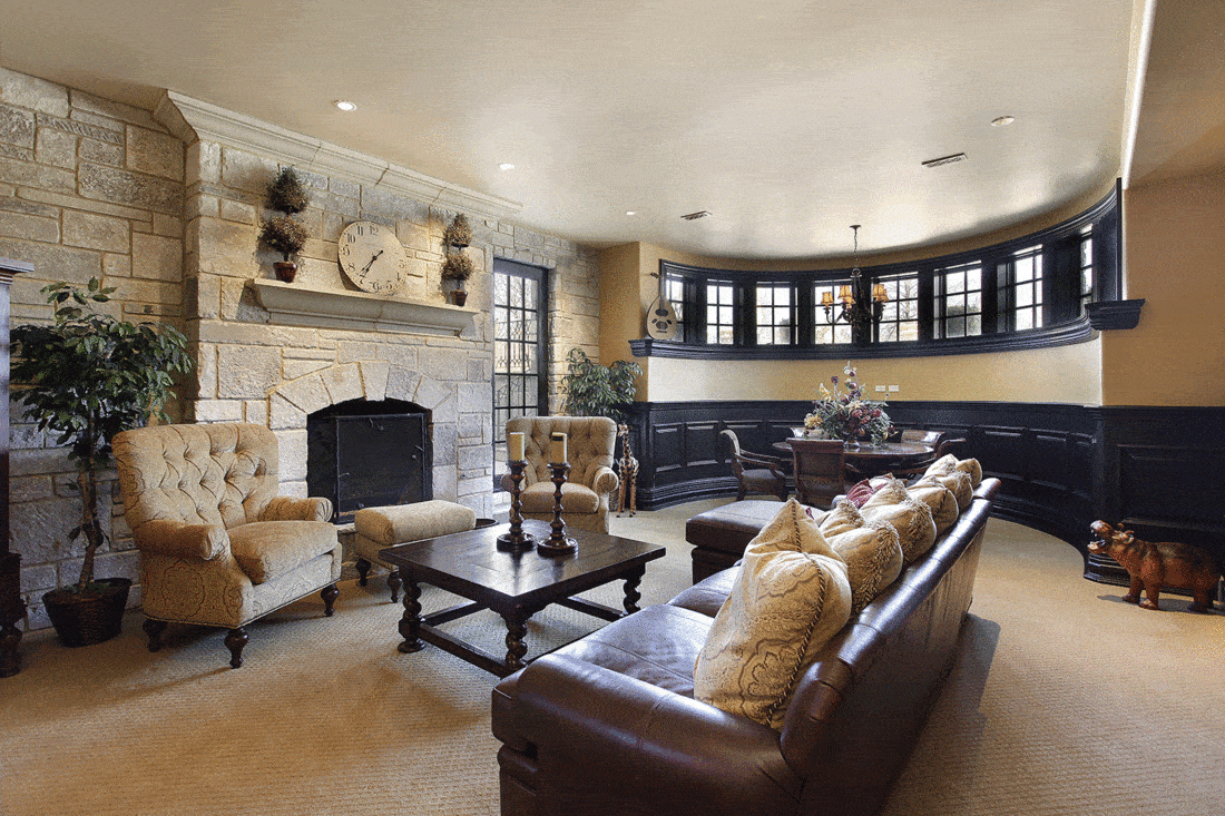 Basement in luxury home with stone fireplace