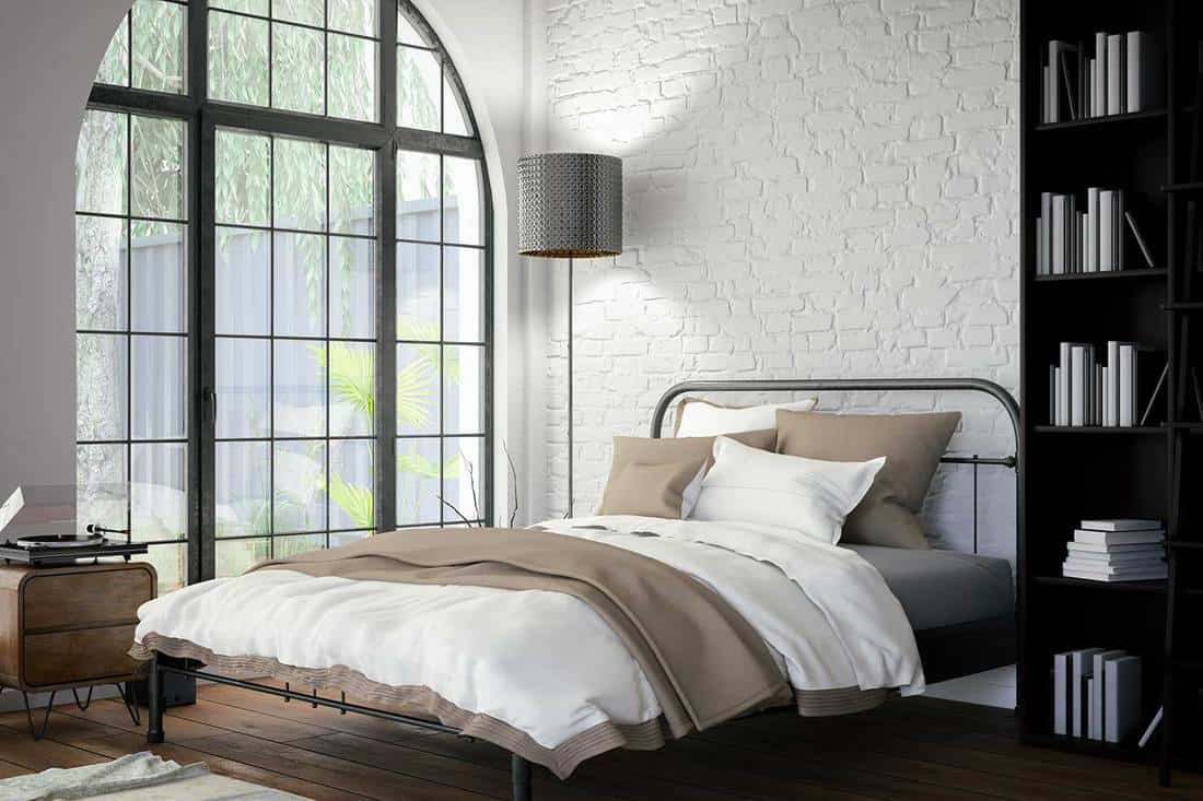 Bedroom with white wall, vinyl and parquet flooring