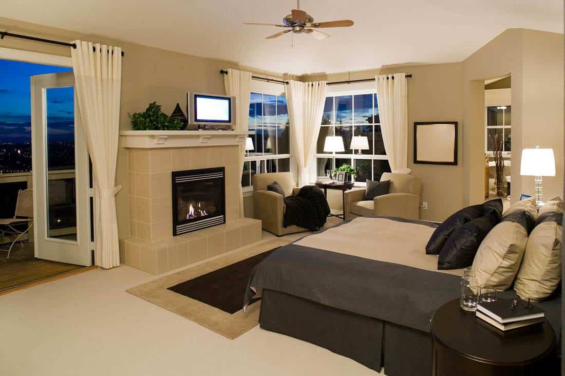 Cozy beige hotel bedroom with balcony