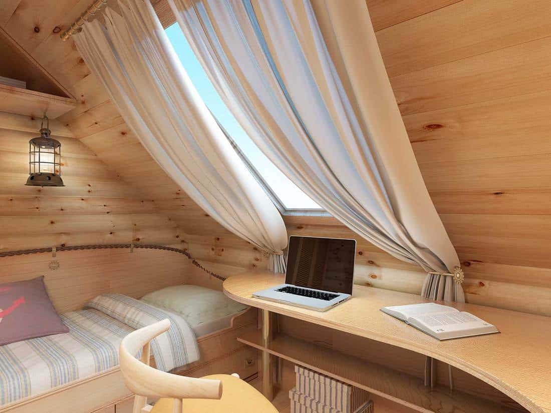 Cozy nautical themed attic bedroom with study table