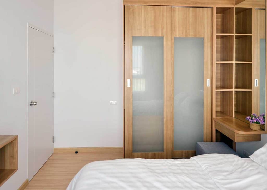 Modern bedroom with wooden wardrobe