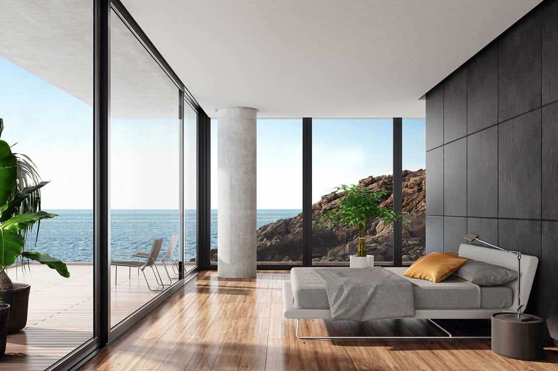 Modern luxurious bedroom in a seaside villa with black stone wall