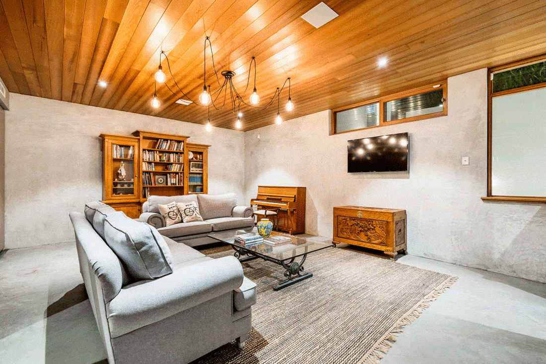 Modern rustic basement living room with wooden ceiling