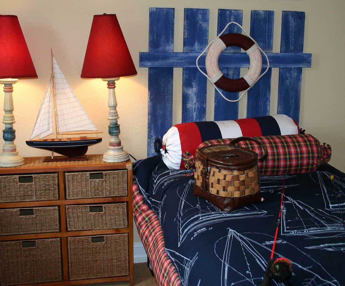 Nautical themed bedroom for little boys with a boat model on the side