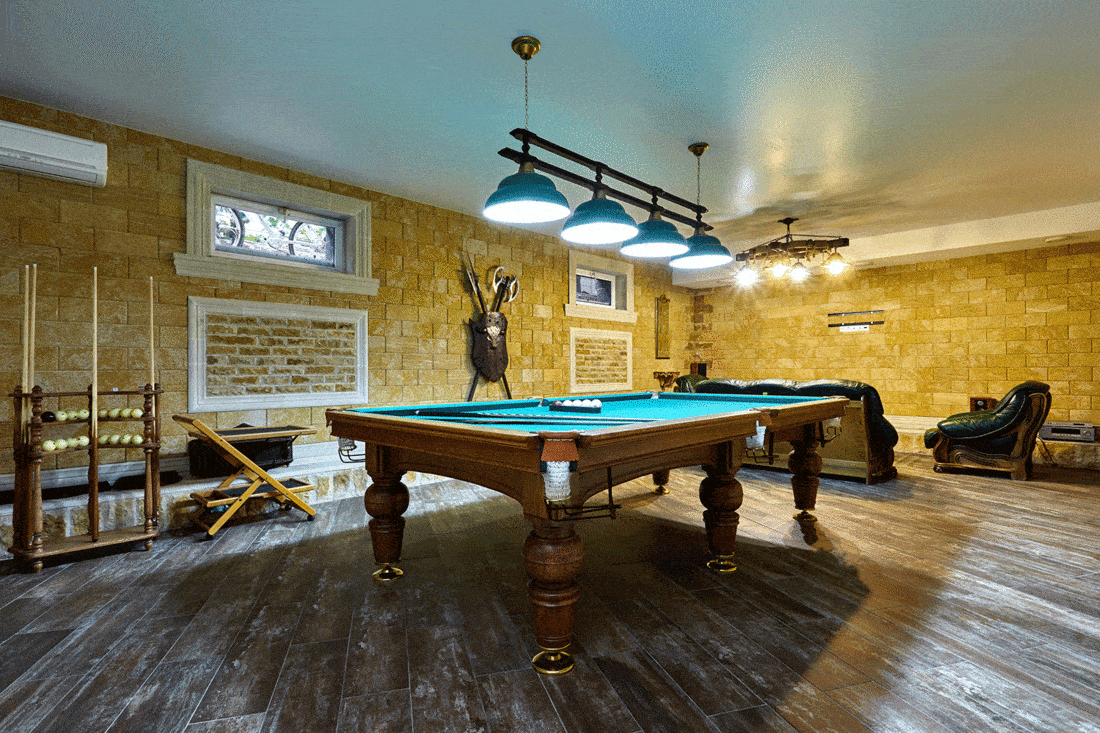 Rustic living room with brick walls and pool table