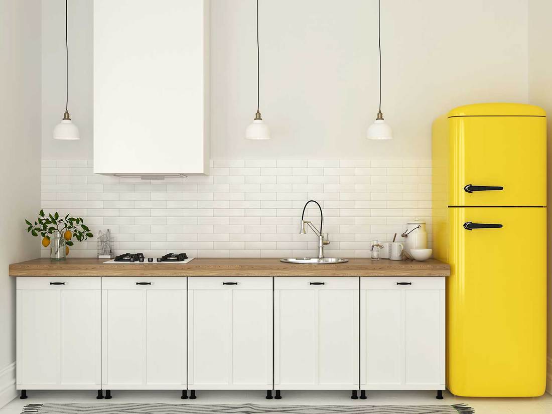 Kitchen with white furniture and a yellow fridge