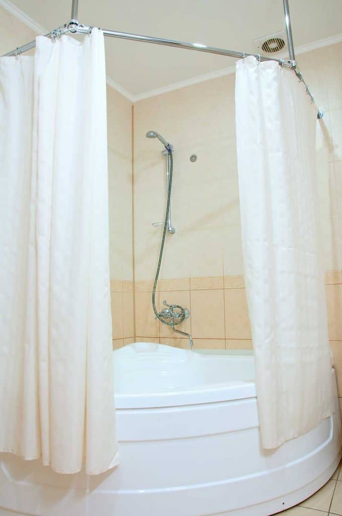 White shower curtain in bathroom interior