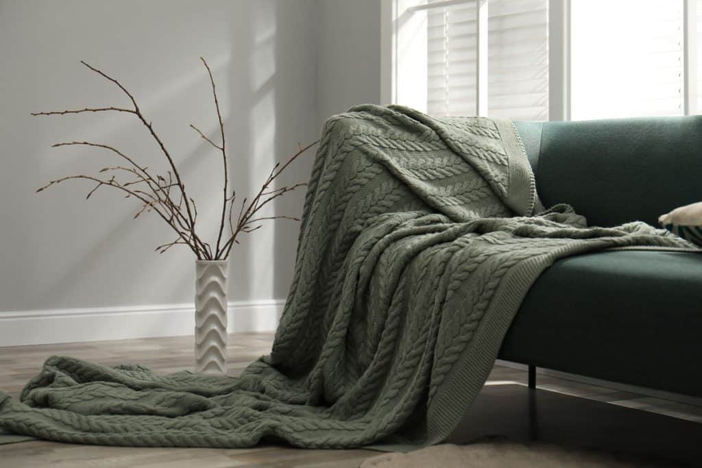 A green colored throw blanket at the living room