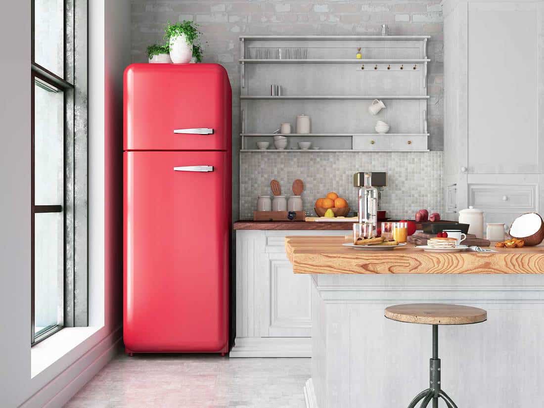 Apartment kitchen with red fridge, island and glass window