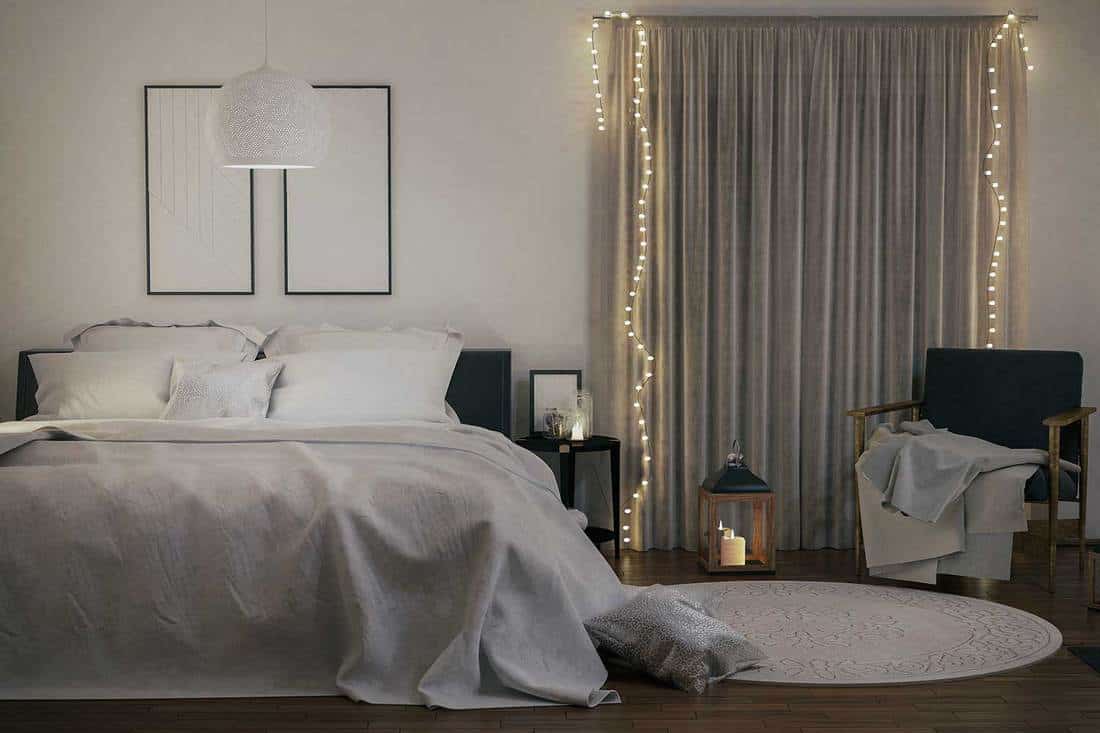 Cozy modern minimalist bedroom with Christmas lights