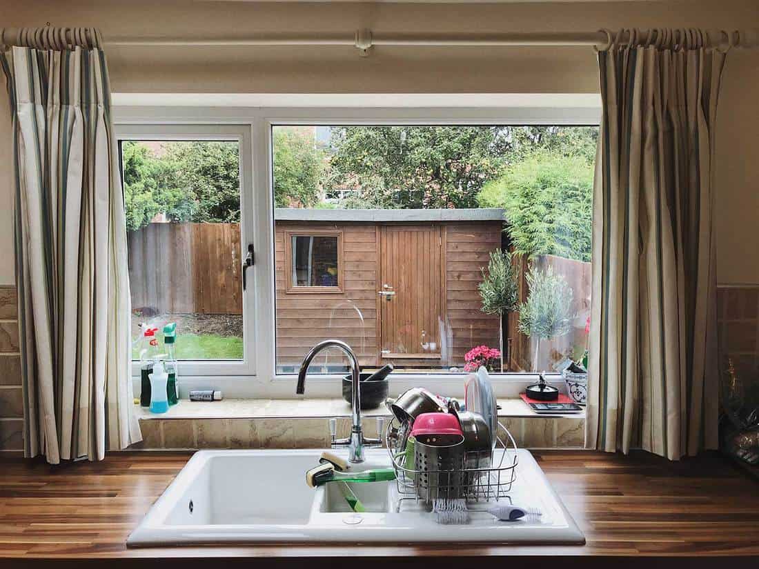 English kitchen window with striped curtain
