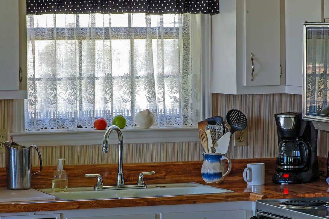 House kitchen with white flower curtain