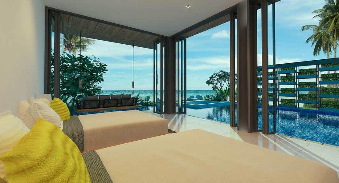 Luxury beach villa bedroom with pool and overlooking sea