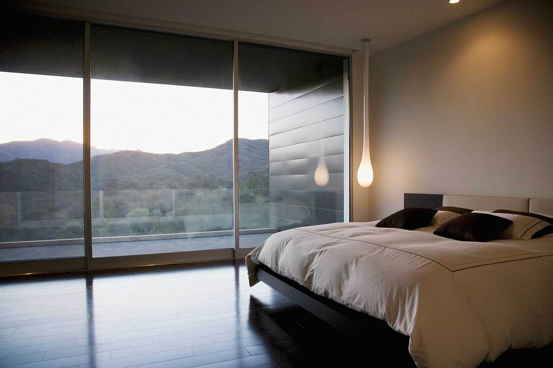 Modern minimalist bedroom with mountain view