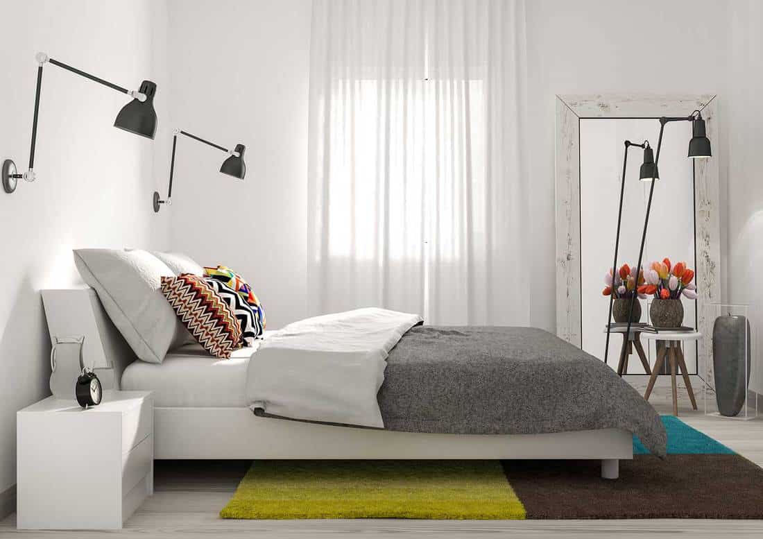 Modern minimalist bedroom with stylish interior, carpet and mirror
