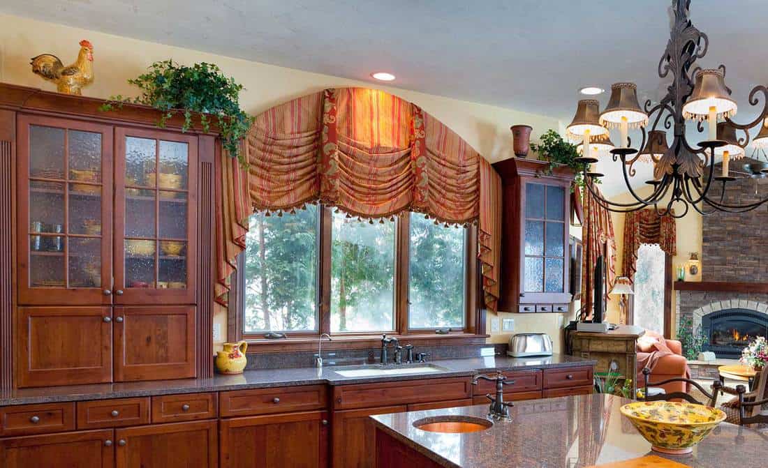 Stylish modern kitchen interior with boho design curtain
