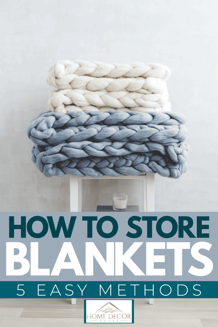 A basket with blankets and pillows near sofa indoors, How to Store Blankets [5 Easy Methods!]