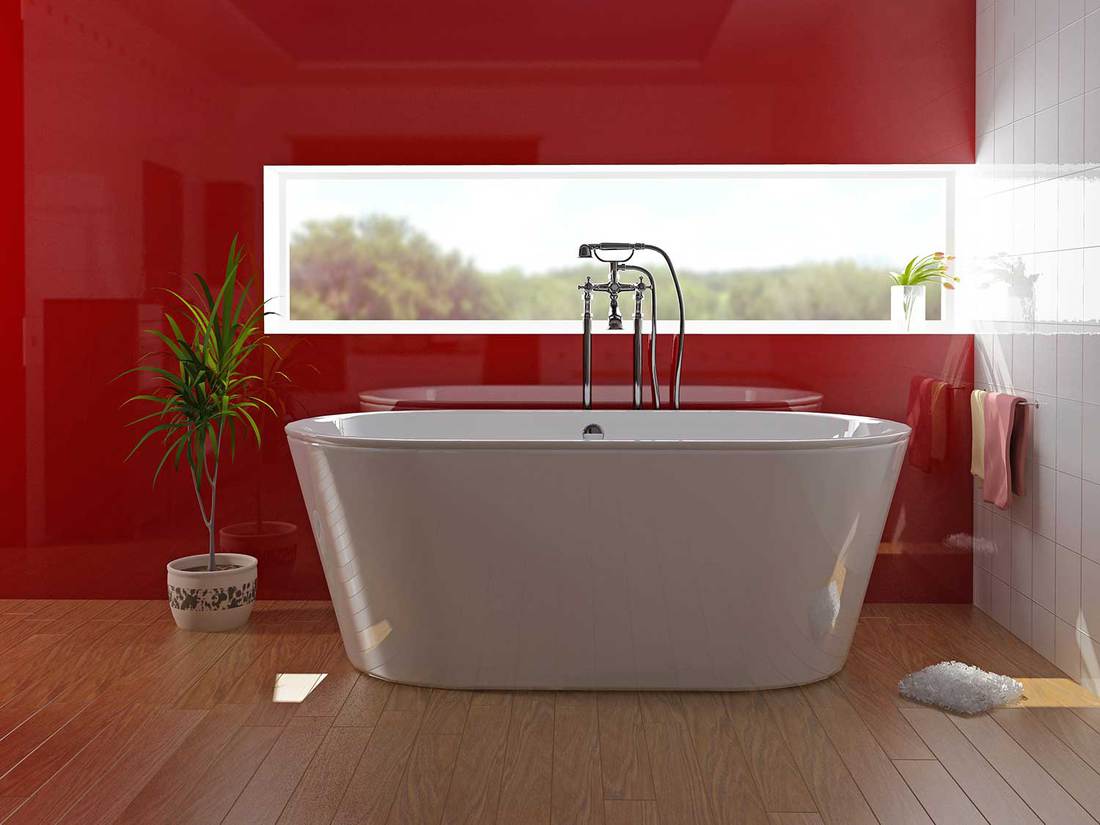 Modern bathroom with bathtub, parquet floors and nature view window