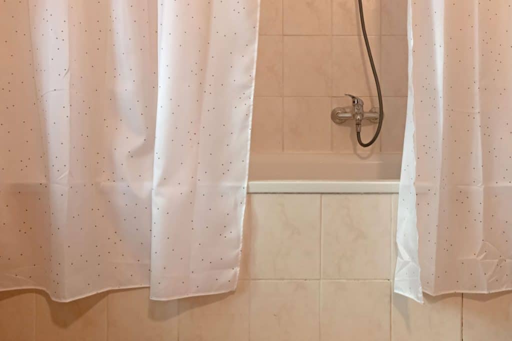 Polka dotted shower curtain inside a bathroom