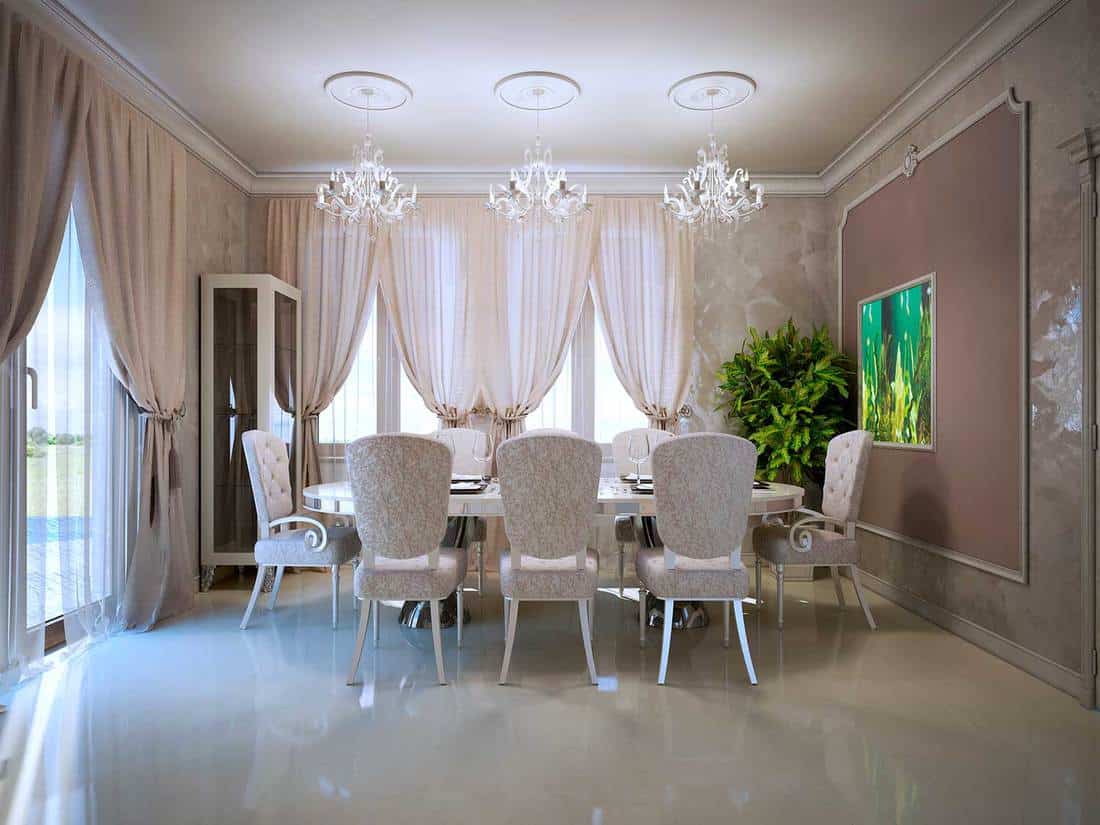 Cozy luxury dining room with fabric upholstered dining chairs and polished concrete flooring