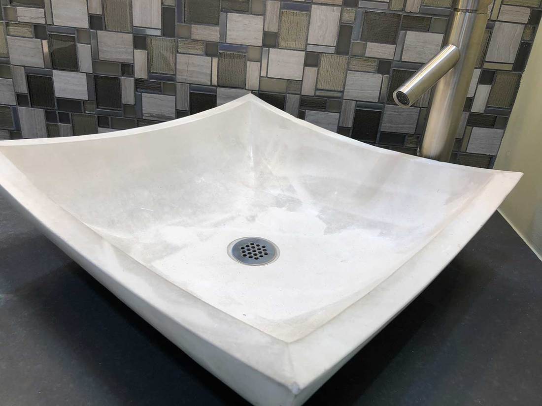 Modern white bathroom sink with chrome faucet