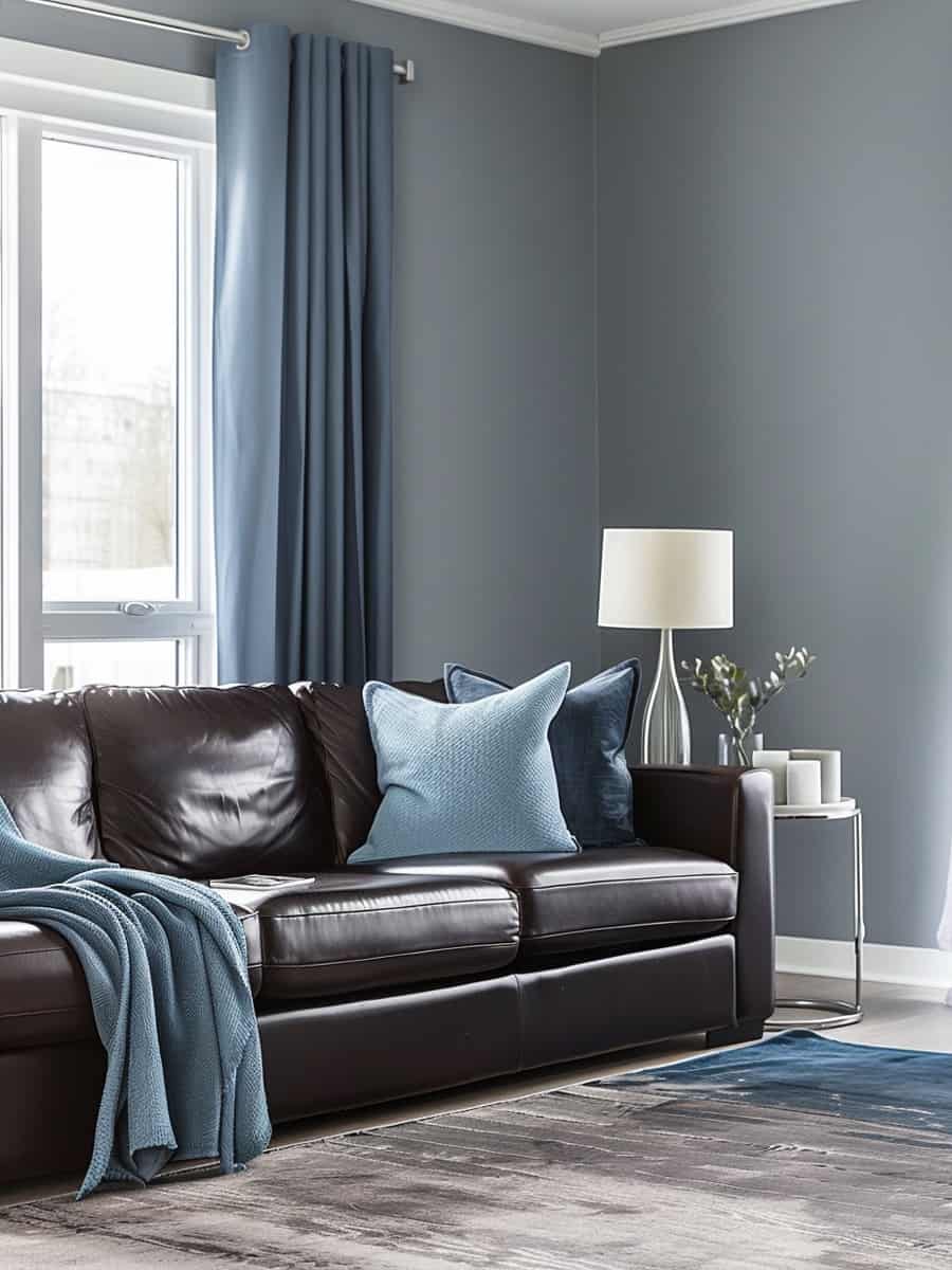 living room's modern aesthetic by pairing a dark brown leather sofa with contemporary side tables, pivoting task-style lamps, and long draping blue curtains against gray walls