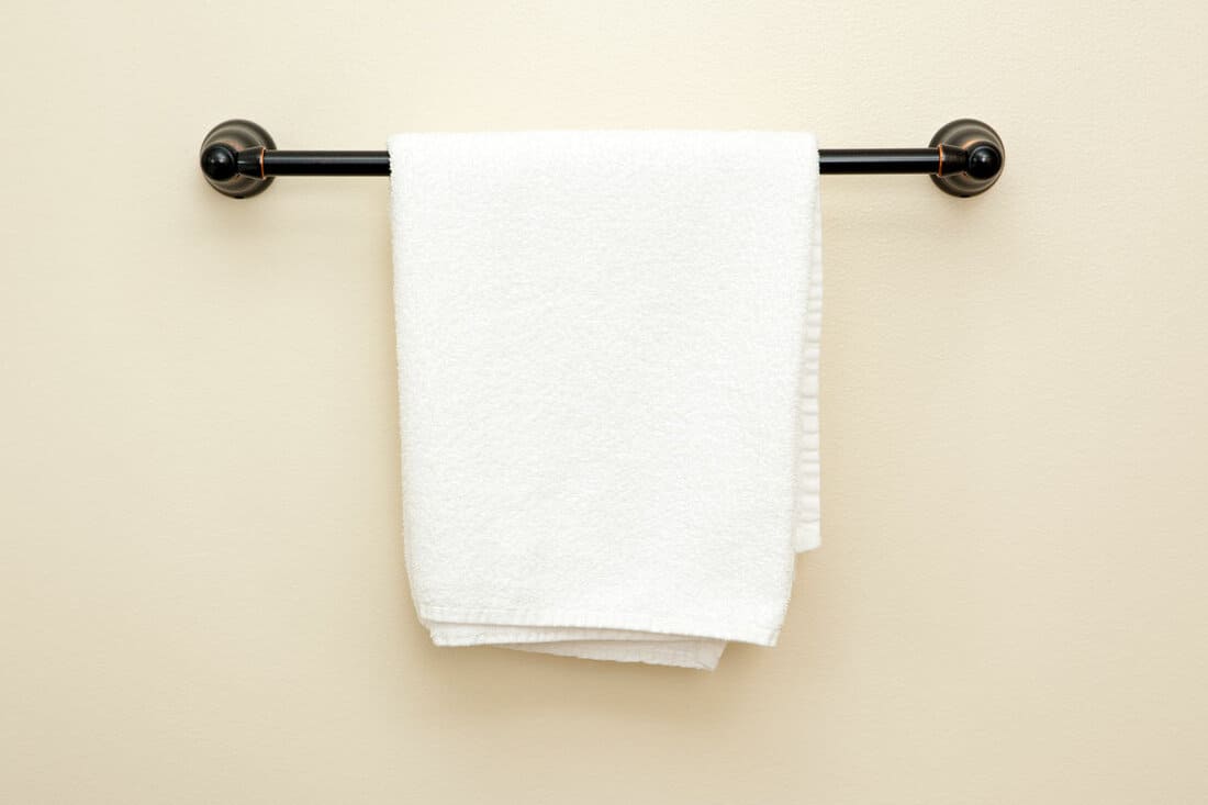 Black towel rack in a beige bathroom