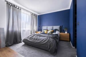 Blue walled bedroom with gray beddings and gray curtains, What Curtains Go With Blue Walls? [15 Awesome Ideas!]