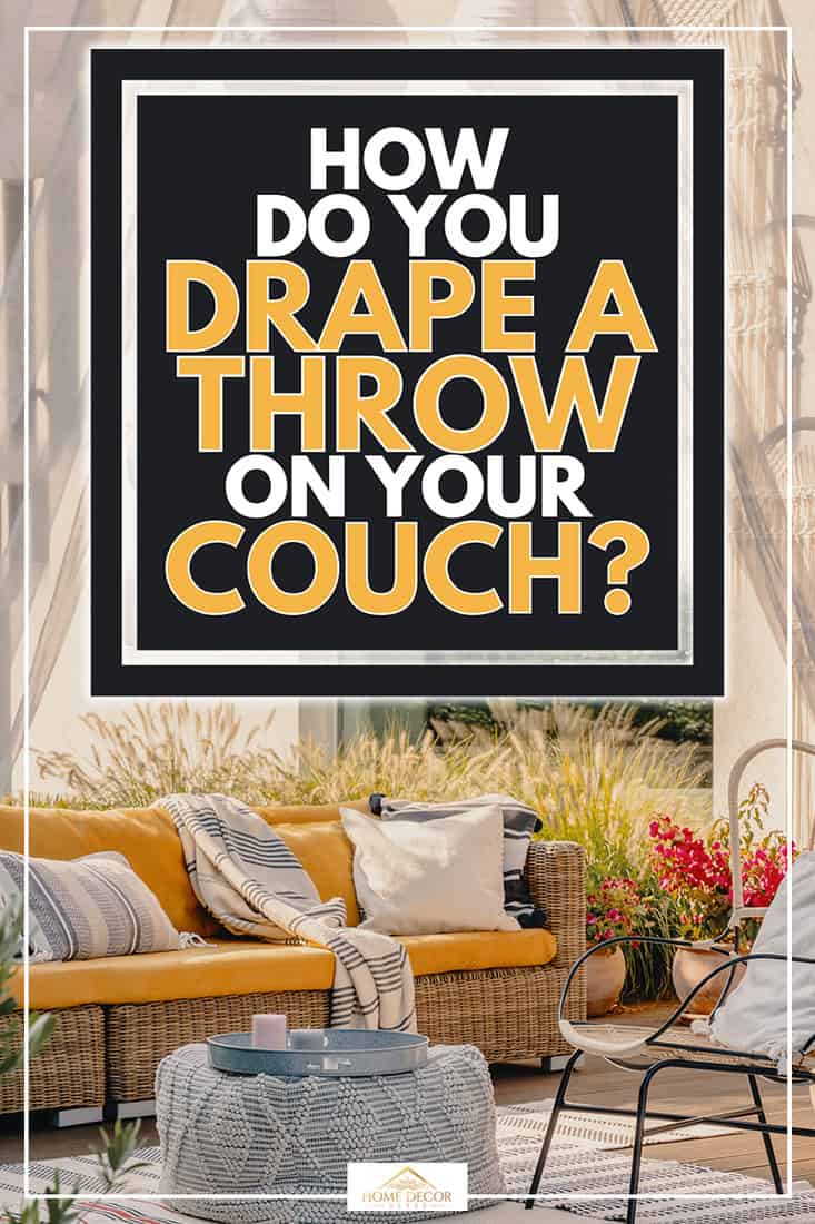 An armchair, pouf as a table and wicker couch on a terrace, How Do You Drape a Throw on Your Couch?