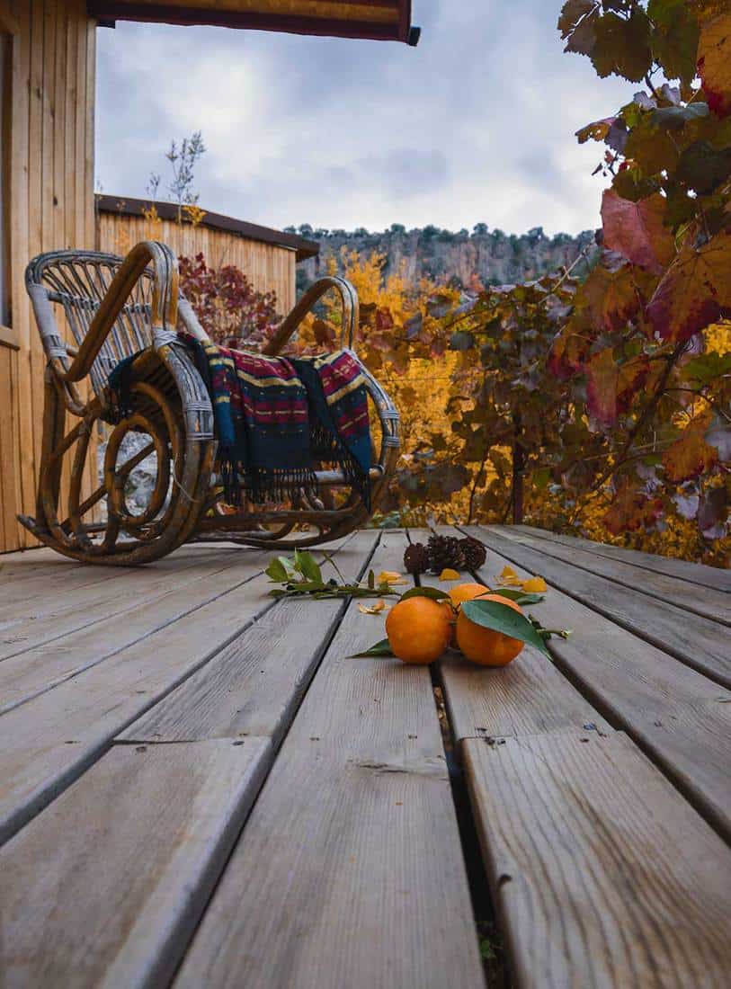 Chaise berçante sur un porche en bois avec une ambiance relaxante