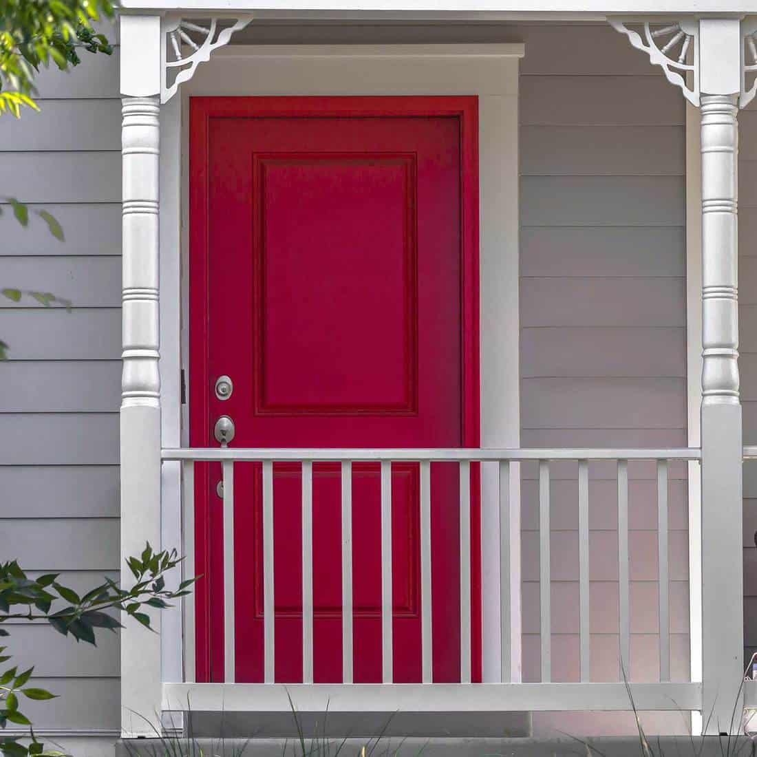 Vibrant red front door and balcony of a home