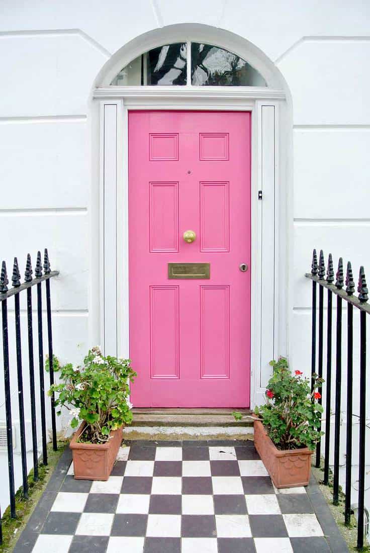 White house with pink door and walkway