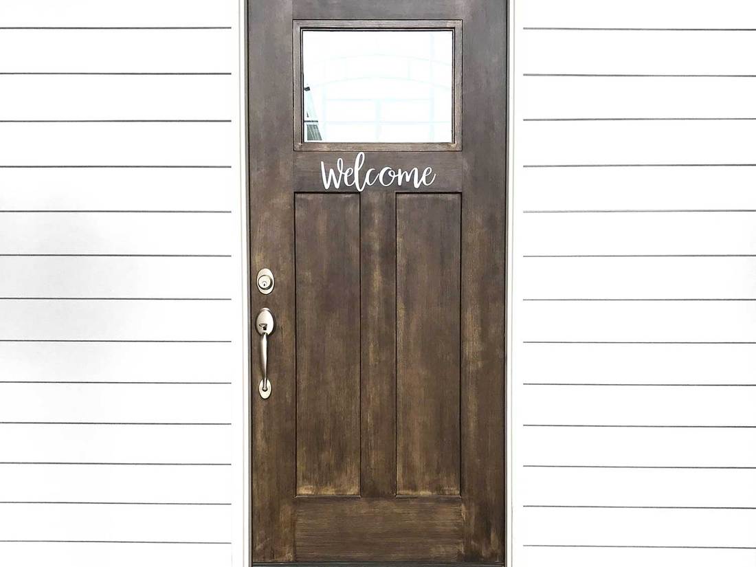 Wooden front door with shiplap siding