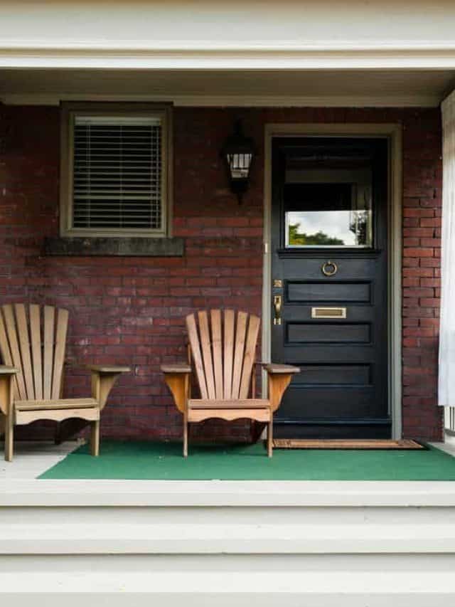 Black door with wooden chair next to it and three step chairs