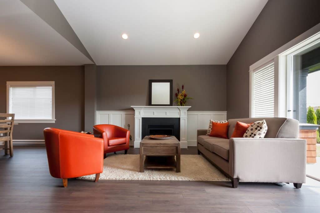 Brown living room with gray flooring and long couches