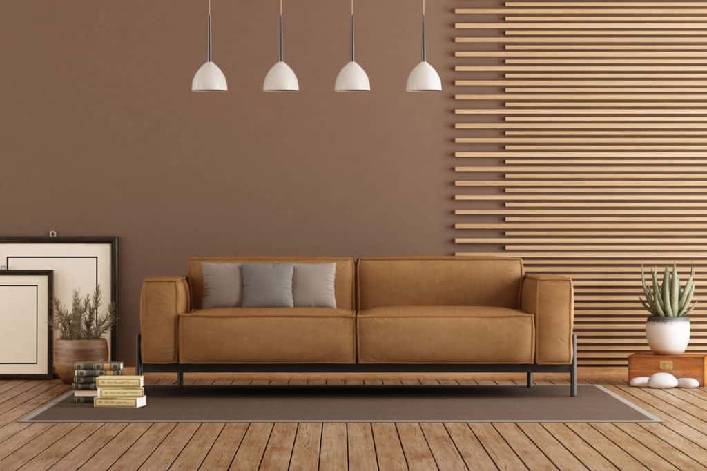 Living room with white hanging lamps and brown couch with matching decorative 1x1 square bars